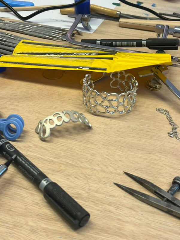 The bench: files, saws and two silver cuffs